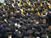 Students at college graduation representing comparing college graduate rates