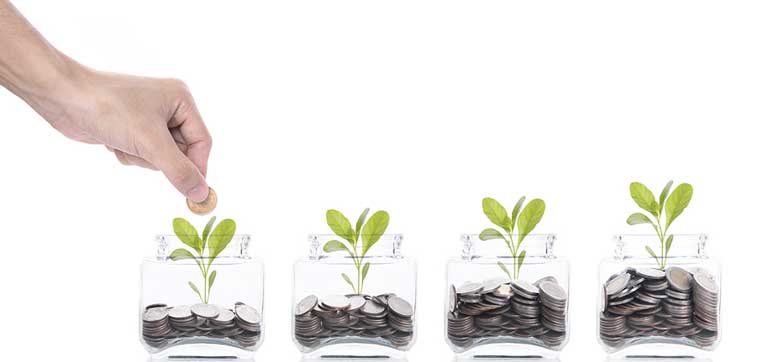 A hand places a coin into the first of four jars, each containing coins and a small plant sprouting from it, symbolizing how colleges that spend the most on teaching students invest in their growth.