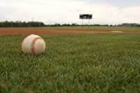 baseball on field representing why some don't play college baseball