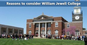Exterior view of a large brick building with a clock tower at William Jewell College on a clear day, with a crowd of people gathered on the lawn.