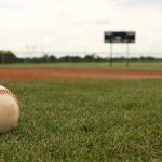 baseball on field representing what you need to do to play college baseball