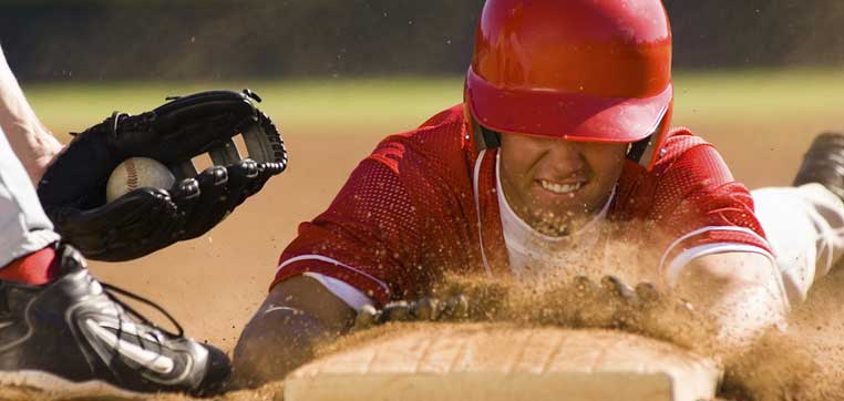 player sliding into base representing How to Get Recruited to Play College Baseball