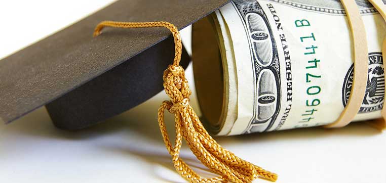 roll of money and graduation hat representing colleges for high income students