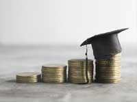 Stacks of coins and graduation hat representing Best Public Universities for Low Income Students