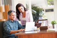 Couple looking at computer and reasons to use CollegeData.com in their college search