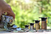 stacks of coins representing problems in comparing college costs