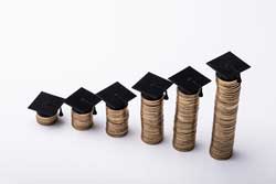 stacks of coins representing numbers to use when comparing colleges