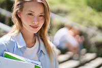 student holding notebooks thinking about ways to make a perfect college list